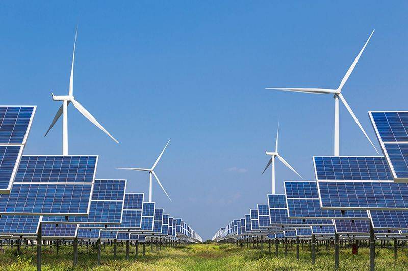 Local energy networks. Solar and wind turbines in a field