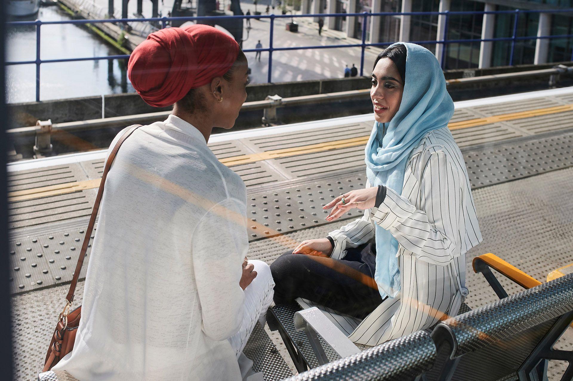 Two women talking on a bench